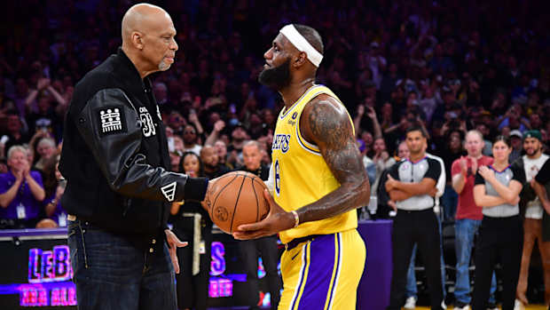 Los Angeles Lakers forward LeBron James (6) shakes hands with former player Kareem Abdul-Jabbar after breaking the NBA all time scoring record against the Oklahoma City Thunder during the second half at Crypto.com Arena.